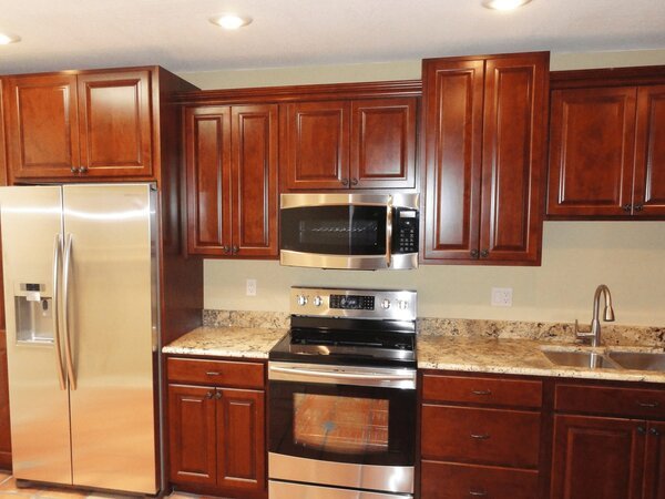 Wood stained raised panel kitchen cabinets